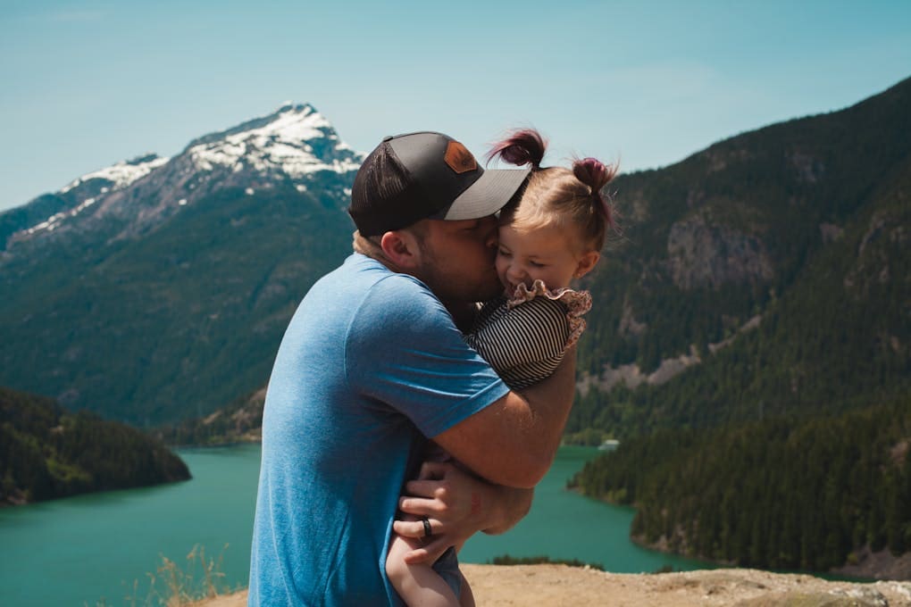 Father Hugging and Kissing his Daughter in a Mountain Landscape. Genetic Methylation Test Brisbane