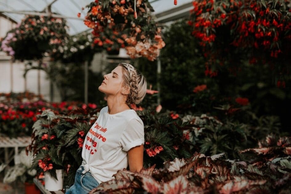 Woman wearing white shirt standing in a greenhouse. How can a Naturopath help me?