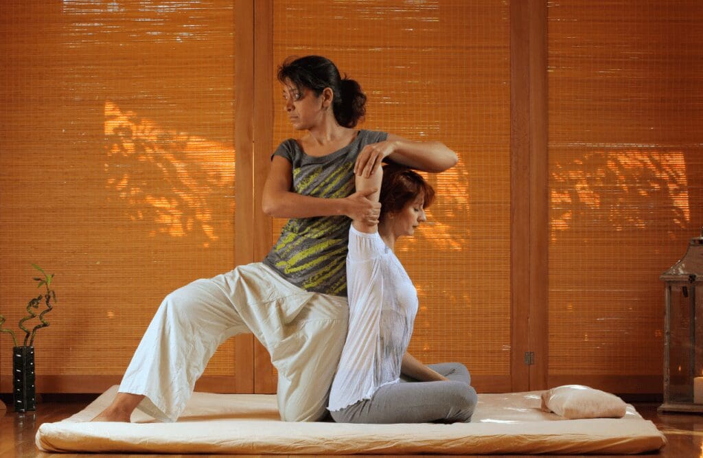 Woman receiving a combination of stretching and acupressure Massage Northgate. Thai Massage. Brisbane Livewell Clinic