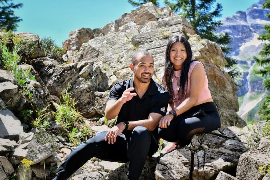 A man and a woman are sitting on rocks. DNA Testing Brisbane