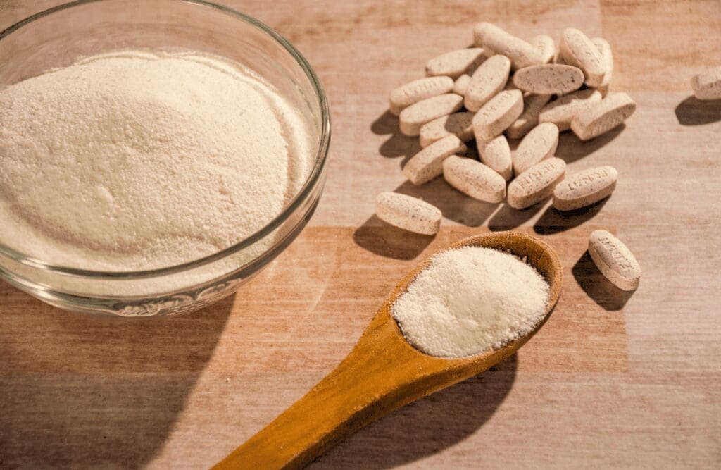 Collagen powder and collagen pills on the wooden table. Health. Brisbane Livewell Clinic
