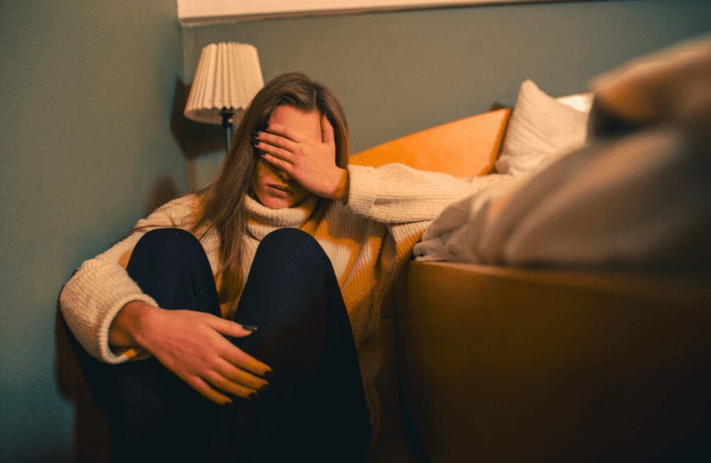 Tired woman sitting on the floor. Stress. Cortisol Test Australia. What is Leaky Gut Brisbane. Fibromyalgia. Brisbane Livewell Clinic