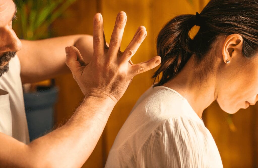 Woman with back pain receives traditional Massage Clayfield. Thai Massage. Massage. Brisbane Livewell