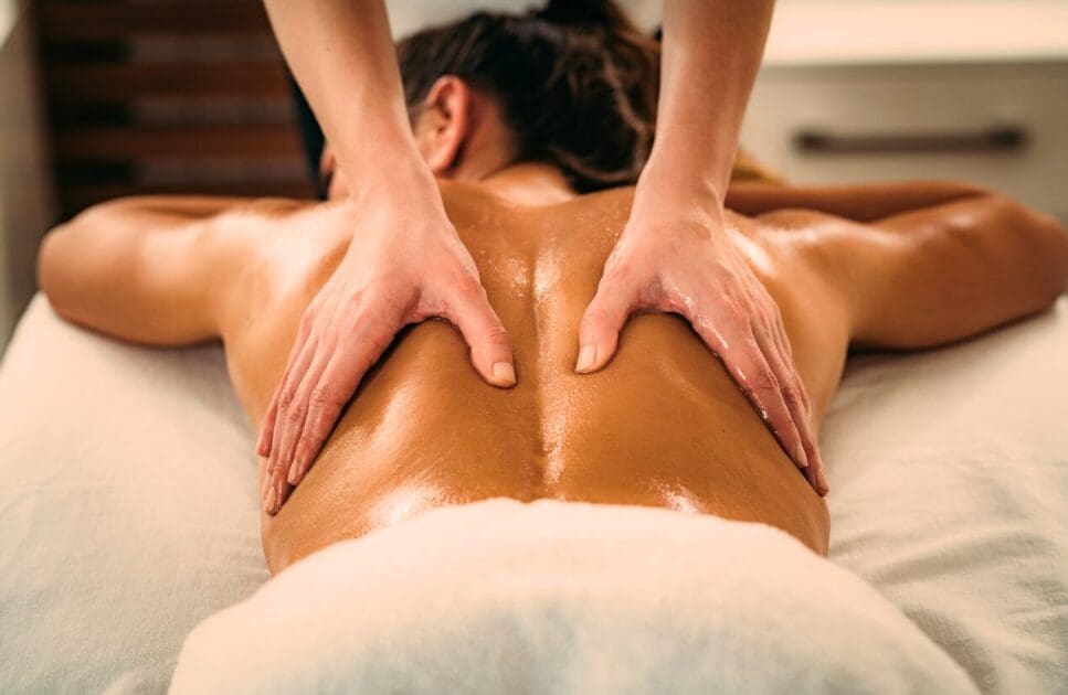 Masseur giving woman a remedial massage. Remedial Massage Near Me. Brisbane Livewell Clinic