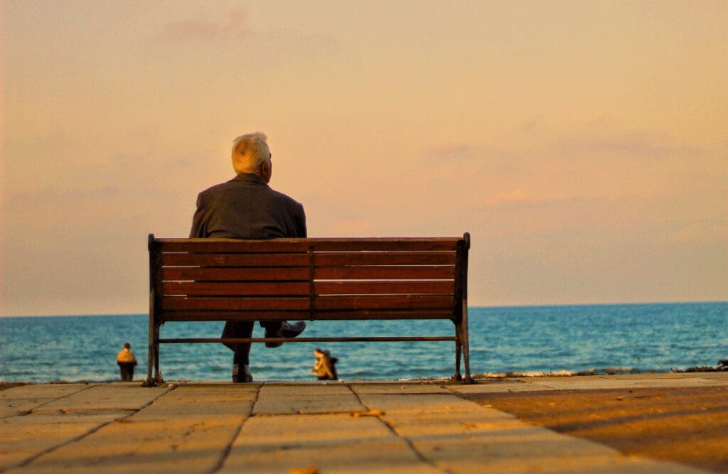 Man sitting on the bench waiting for the sunset. How much is Hypnotherapy. Brisbane Livewell Clinic