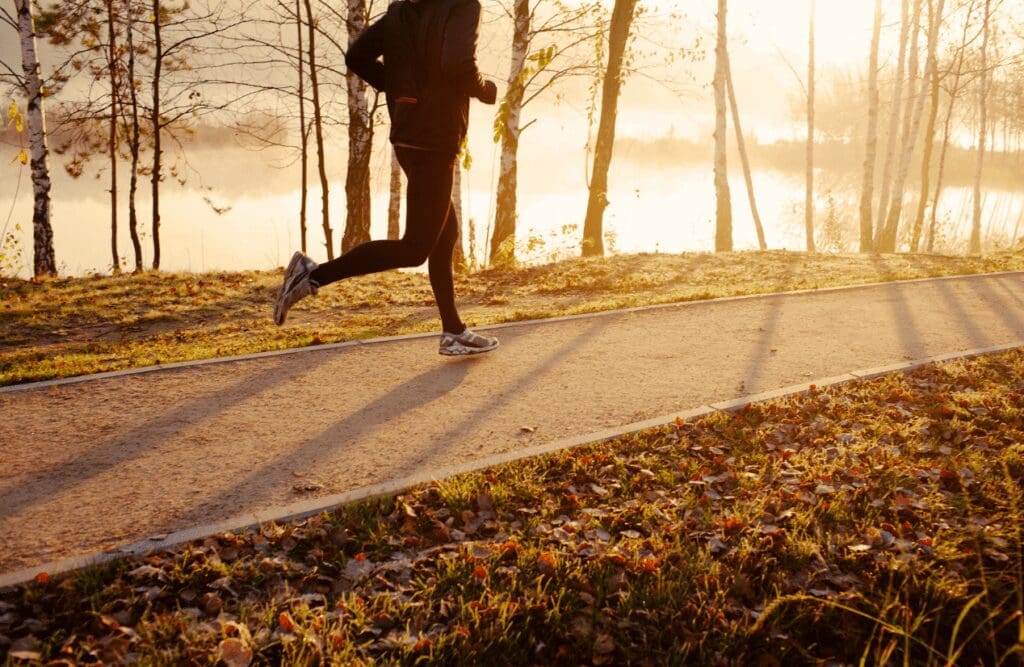 Man running on road during sunrise. Hypnotherapy Weight Loss Near Me. Osteopathy and Sports Recovery. Brisbane Livewell Clinic