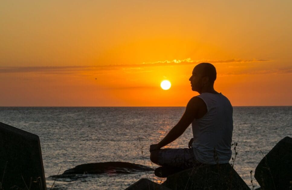 Man sitting on the rocks near the beach. Benefits of Bowen Therapy. What is Leaky Gut Australia. I Don't Know Who I Am Anymore. Osteopath for Posture and Alignment. Brisbane Livewell Clinic