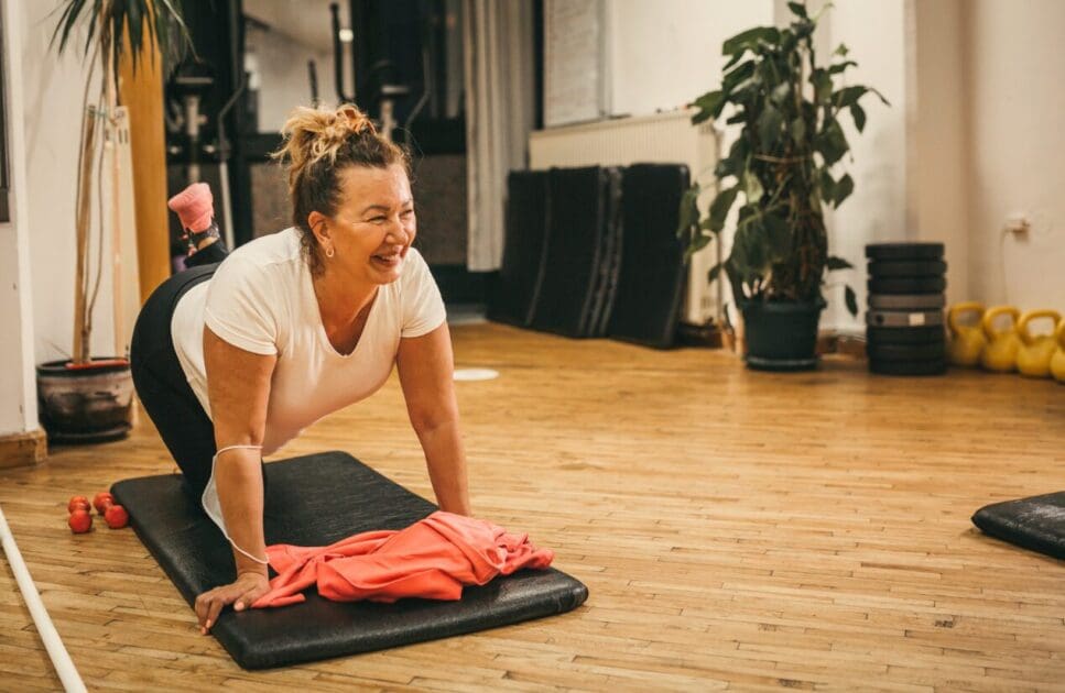 Middle-aged woman doing home exercise. Happy Menopause. Menopause. Osteopath Carina. Osteopath for Hip Pain. Brisbane Livewell Clinic