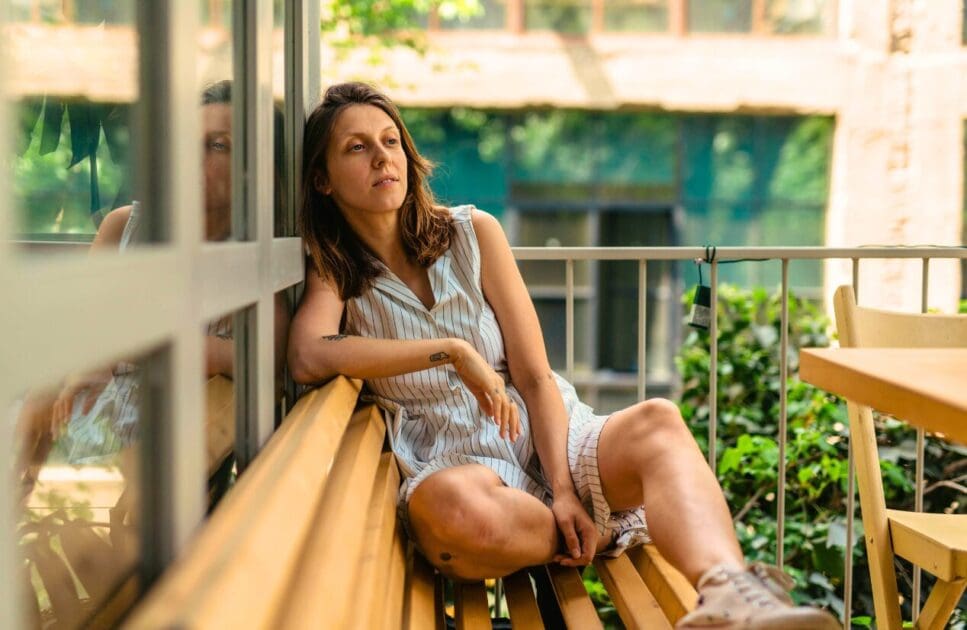 Woman sitting on the balcony. Happy Menopause. Test Cortisol at Home. IBS Awareness. Acupuncture for Menopause. Brisbane Livewell Clinic