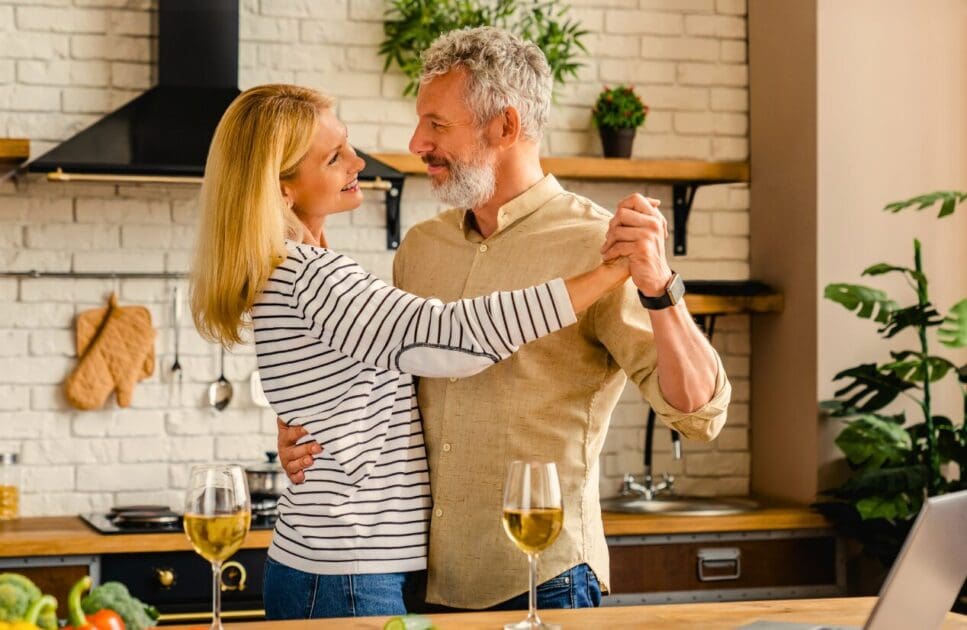 Middle-aged couple dancing at home kitchen. Middle age. MTHFR Gene Test. Low Libido. Holistic Counselling Wavell Heights. Brisbane Livewell Clinic