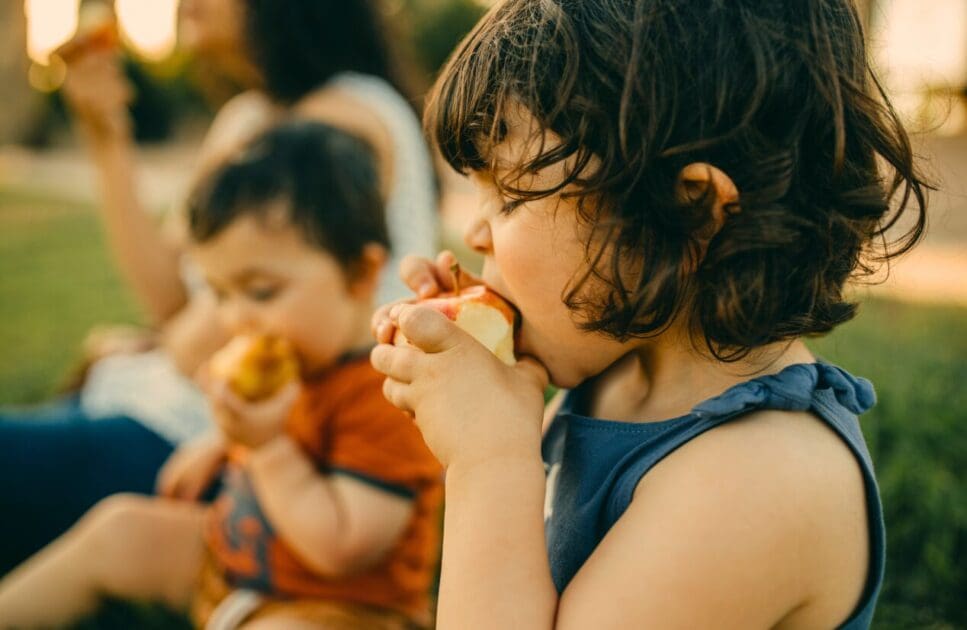 Two children eating apples. Naturopathy Helps Eczema. Iron Deficiency. Clinical Nutritionist Murarrie. Brisbane Livewell Clinic