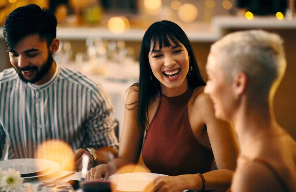 Group of friends at a table, laughing together. Stop Back Pain. What is Holistic Counselling. Acupuncture for Migraines. Food Intolerance Testing Brisbane. Brisbane Livewell Clinic