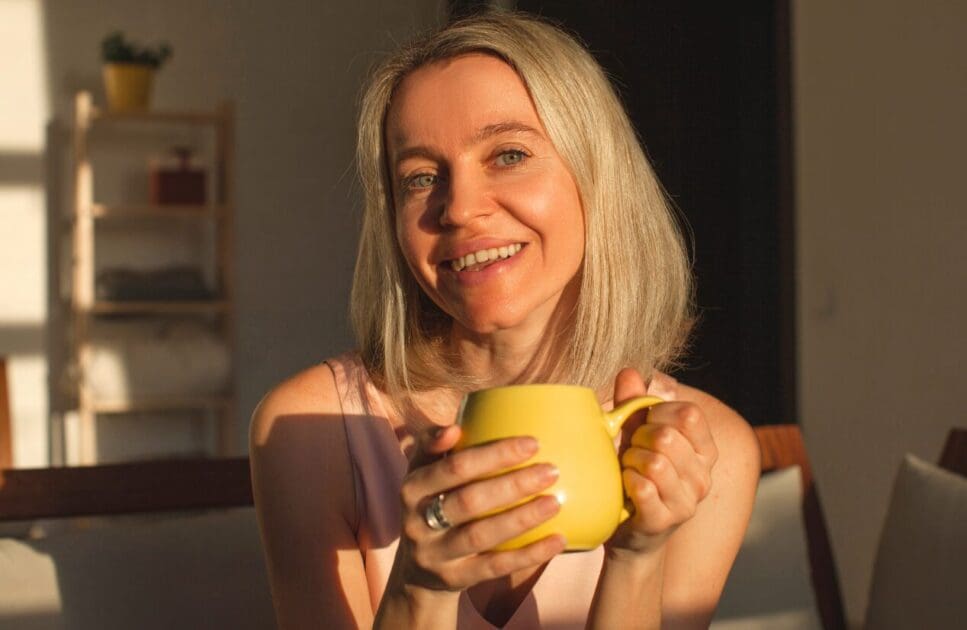 Middle-aged woman holding a cup of tea. Food Allergy Testing. Clinical Nutritionist Carina. Brisbane Livewell Clinic