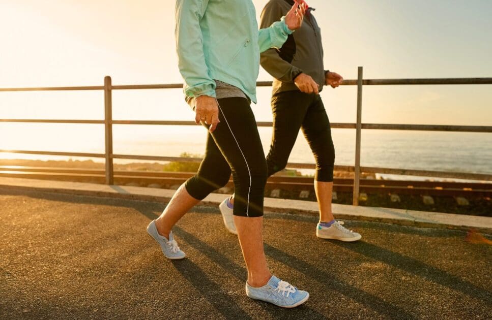 Two women walking during sunsrise. IBS. Osteopath South Brisbane. Osteopath for Foot Pain and Plantar Fasciitis. Brisbane Livewell Clinic