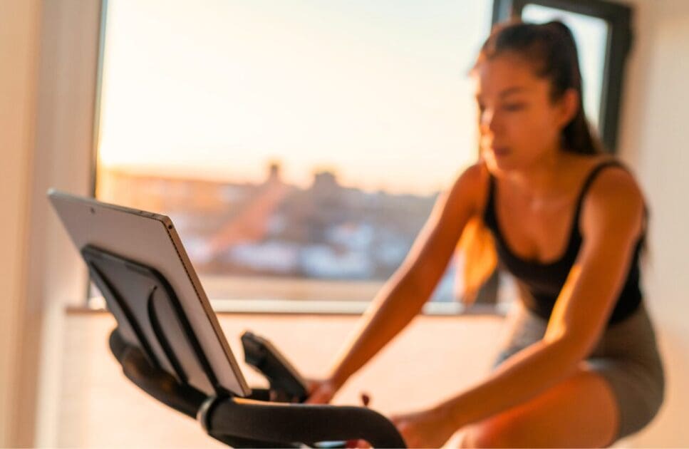 Woman exercising on a stationary bike. IBS. Brisbane Livewell Clinic