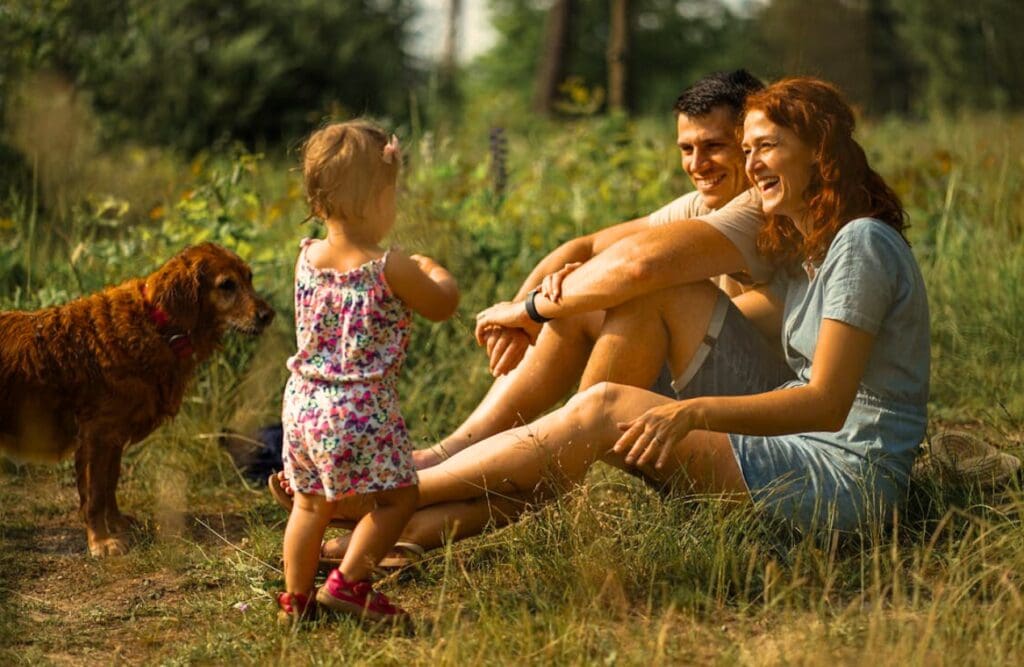 A cheerful family together with their dog enjoying time outdoors. Clinical Hypnotherapy Morningside. Brisbane Livewell Clinic