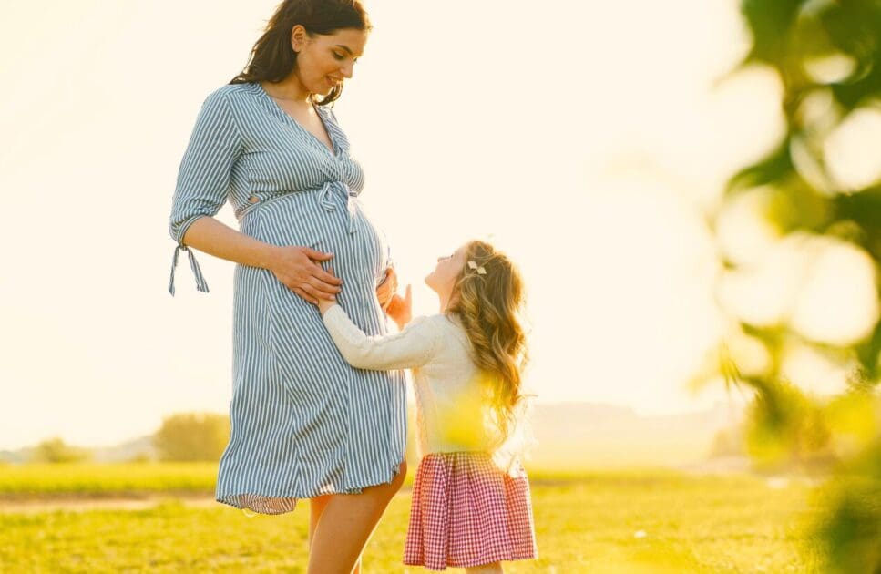 Pregnant mother and her daughter sharing moment together. Pregnancy Massage Near Me. Pregnancy and Acupuncture. Prenatal Naturopath. Brisbane Livewell Clinic