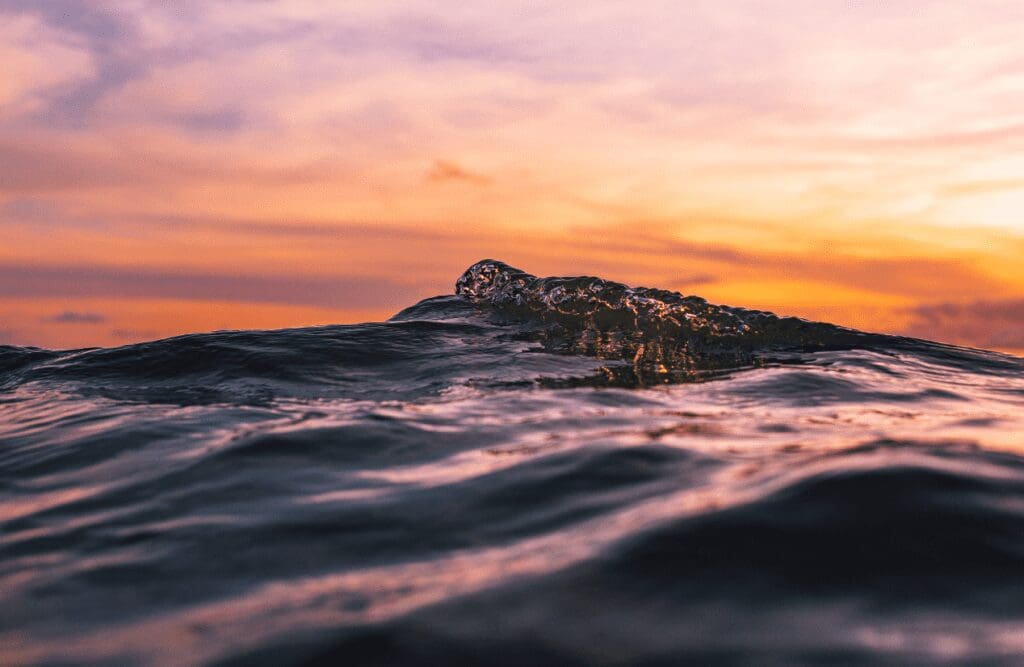 Ocean waves under orange sky. Hypnotherapy cost in Australia. Brisbane Livewell Clinic