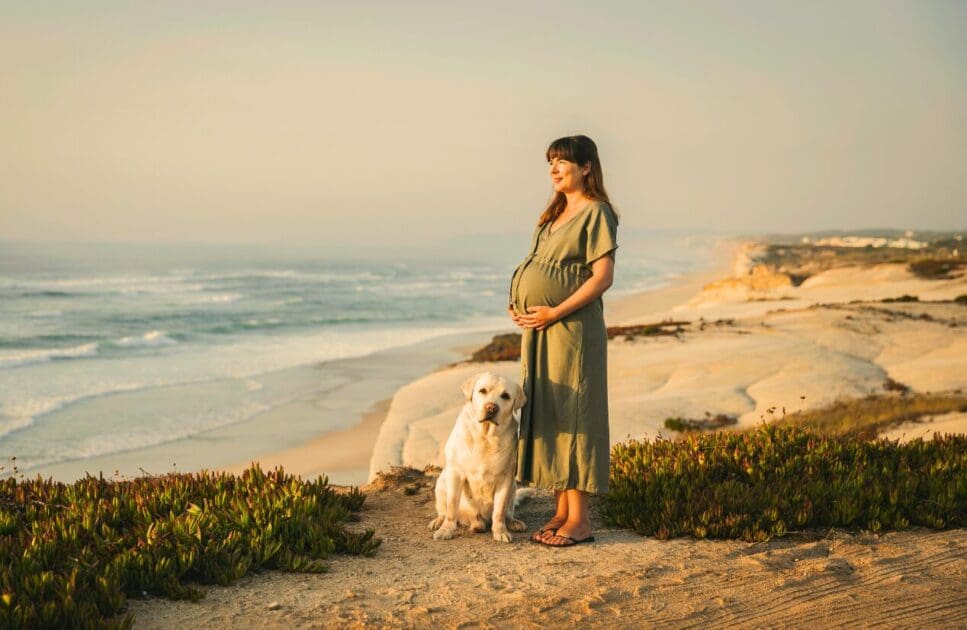 Pregnant woman enjoying at the beach with her dog. Pregnancy Massage Near Me. Quality Sleep. Brisbane Livewell Clinic