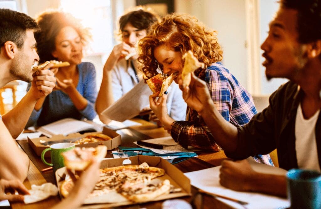 Friends eating pizza together. Binge eating. Leaky Gut Syndrome. Brisbane Livewell Clinic