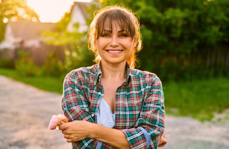 Smiling woman holding flowers in her hands. Menopause Clinic Near Me. Clinical Hypnosis for Menopause. Cosmetic Acupuncture. Kinesiology can help weight gain. Naturopath anxiety. Brisbane Livewell Clinic. Holistic Counselling with Nathan Gurry