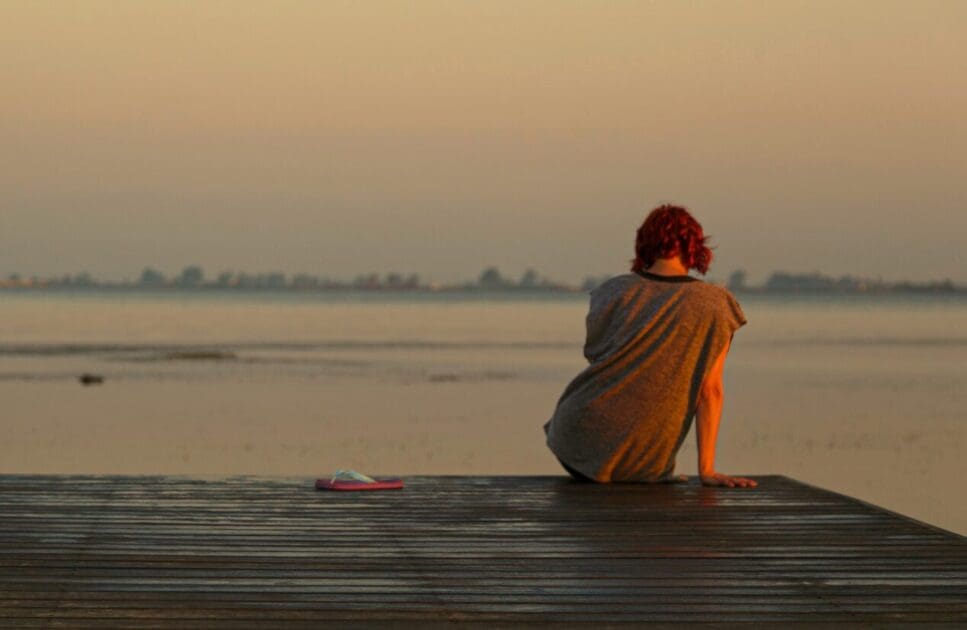 Person sitting at the end of a dock. Chronic Fatigue Treatment Brisbane. Brisbane Livewell Clinic