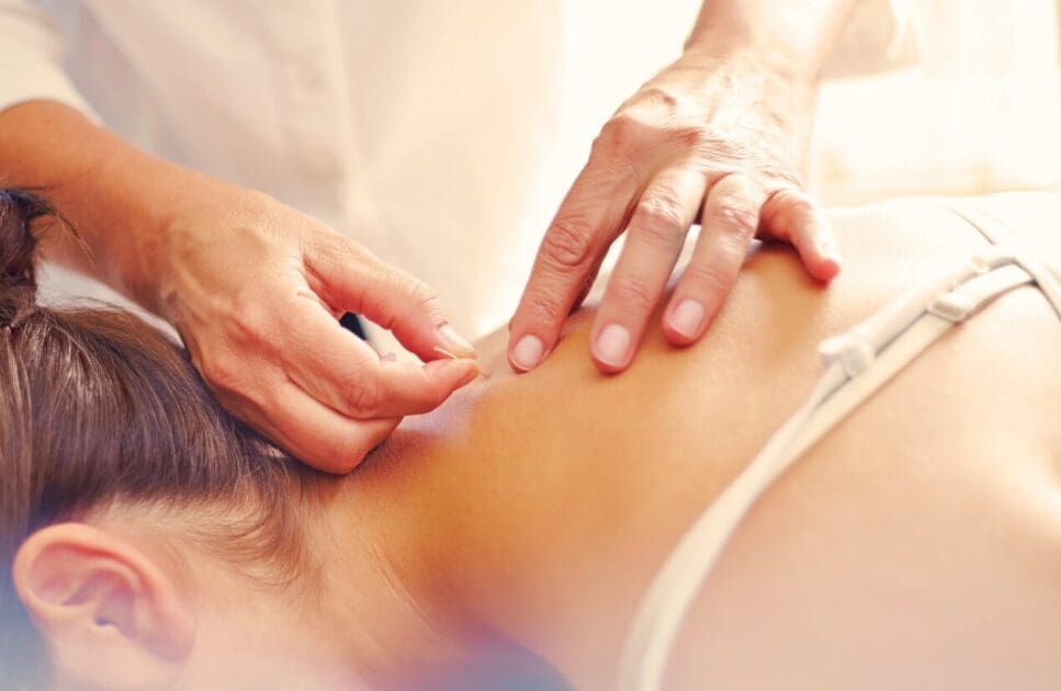 Therapist performing dry needling on woman's back. Dry Needling Near Me. Brisbane Livewell Clinic