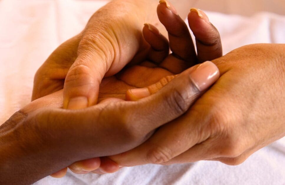 Masseur giving person a hand reflexology. Reflexology Near Me. Brisbane Livewell Clinic
