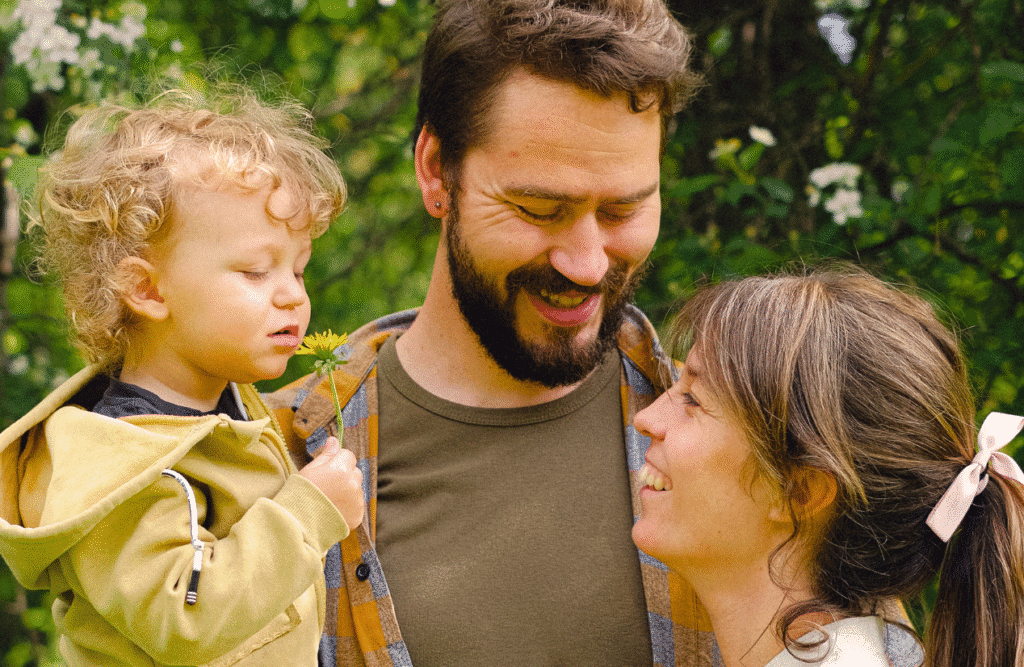 A family of three looking happy together. Naturopath Noosa. Clinical Hypnotherapist Brisbane. Naturopath Brisbane. Brisbane Livewell Clinic
