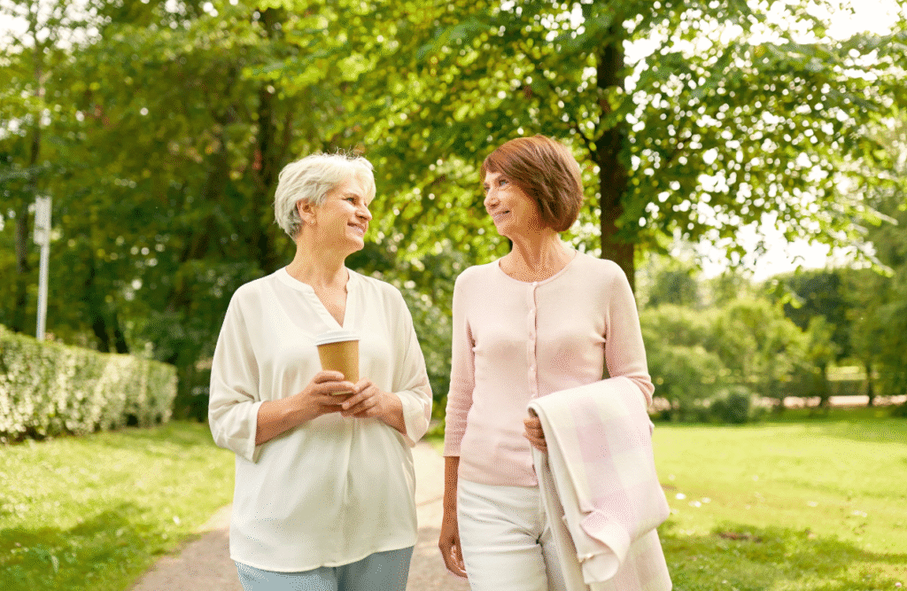 Two women walking in the park. Gut Microbiome Testing Australia. Clinical Hypnosis for Menopause. Acupuncture for Menopause. Hypnotherapy Weight Loss Near Me. Brisbane Livewell Clinic