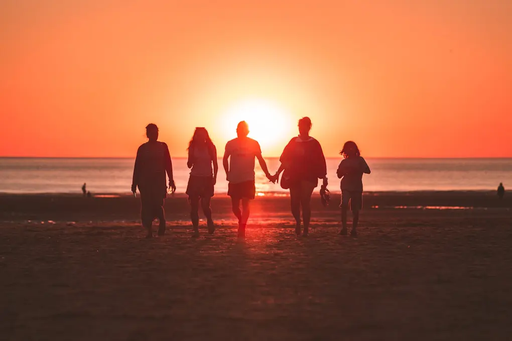 Family walking on the seashore during golden hour. Our Services at Brisbane Livewell Clinic. Hypnotherapy Locations we Service