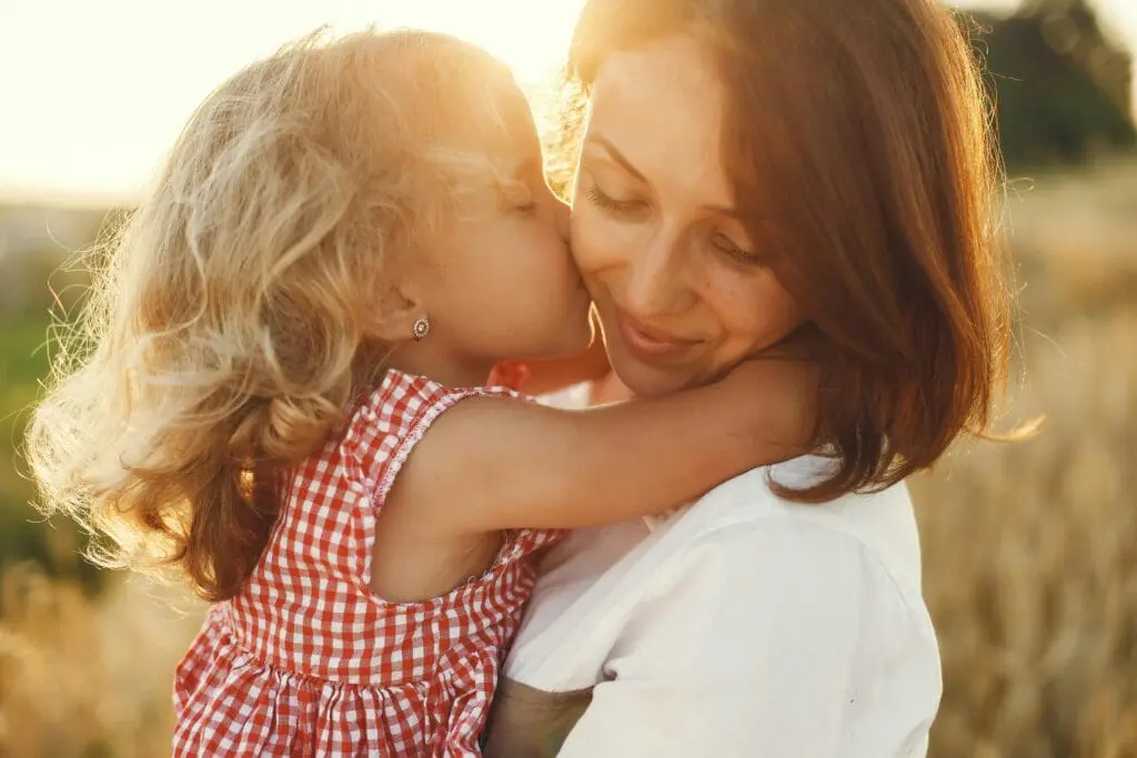 Daughter kissing her mother on the cheeks. MTHFR Gene Test. Brisbane Livewell Clinic