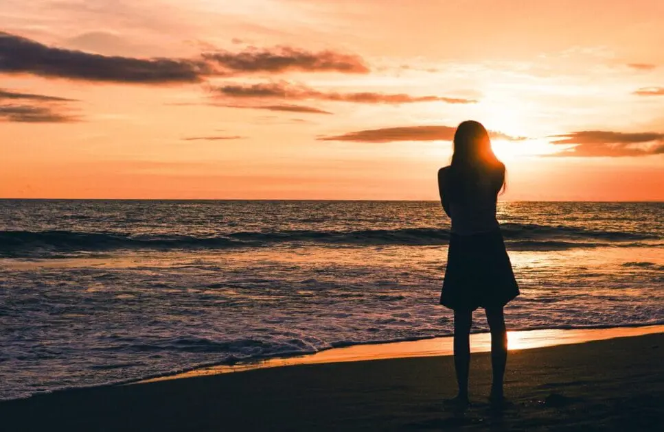 Silhouette of a woman standing near the ocean. Hormonal Imbalance. Iron Deficiency. Brisbane Livewell Clinic
