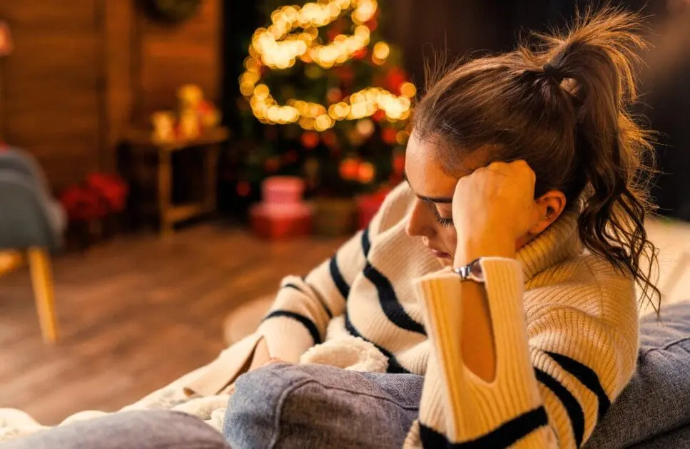 Woman sitting on the sofa. Hormonal Imbalance. Holistic Counselling for Sensory Overload. Spiritually Disconnected Holistic Counselling. Brisbane Livewell Clinic