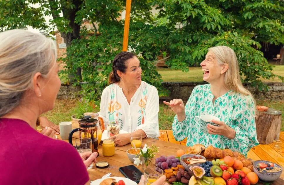 Three women gathered around the table to eat. Coeliac Disease. Clinical Nutritionist Cannon Hill. Brisbane Livewell Clinic