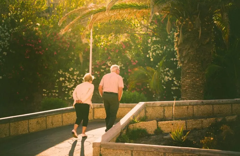 Couple walking together outdoors. Vulnerable to Osteoarthritis. Brisbane Livewell Clinic