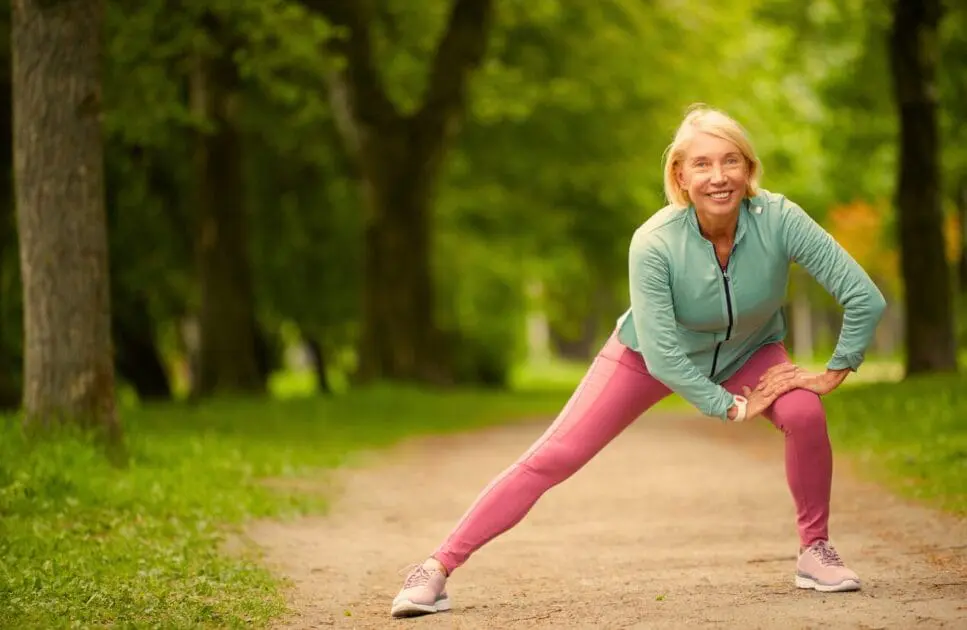 Middle-aged woman doing leg stretching. Vulnerable to Osteoarthritis. Osteopath for Hip Pain and Pelvic Discomfort. Brisbane Livewell Clinic