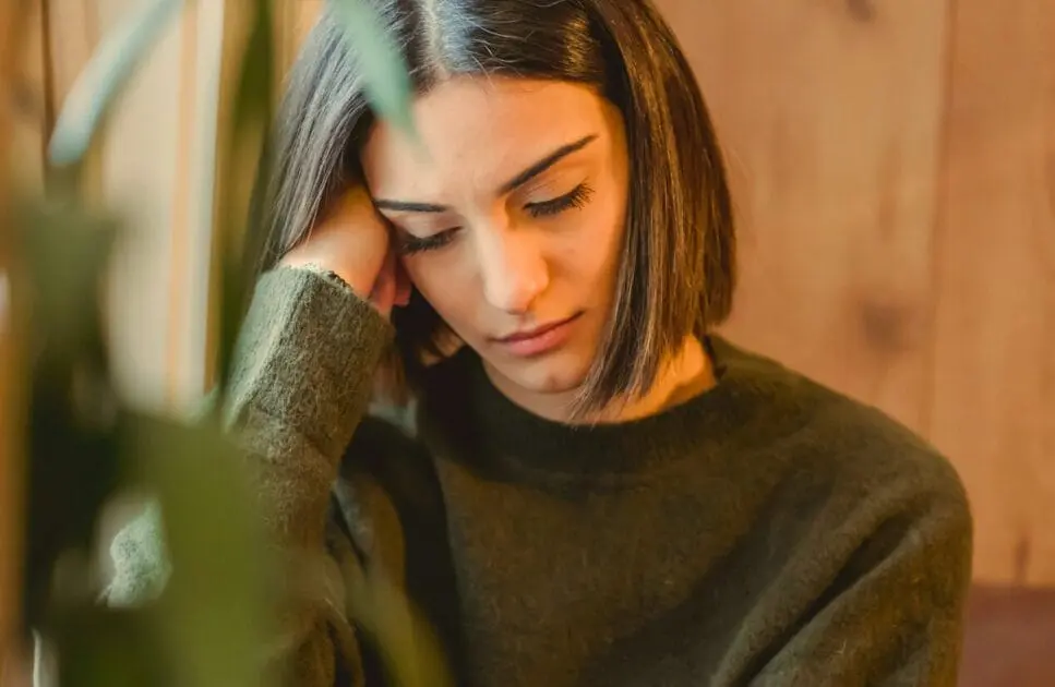 Unhappy woman sitting on a couch. Detox Diet. Health Screening. Brisbane Livewell Clinic