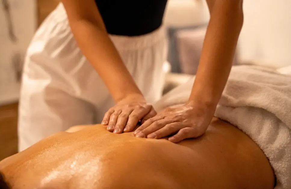 Woman enjoys a relaxing back massage. Benefits of Therapeutic Massage. Massage. Brisbane Livewell Clinic