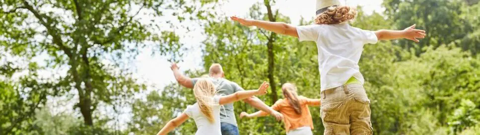 Family having fun playing in the park. Natural Dispensary. Brisbane Livewell Clinic