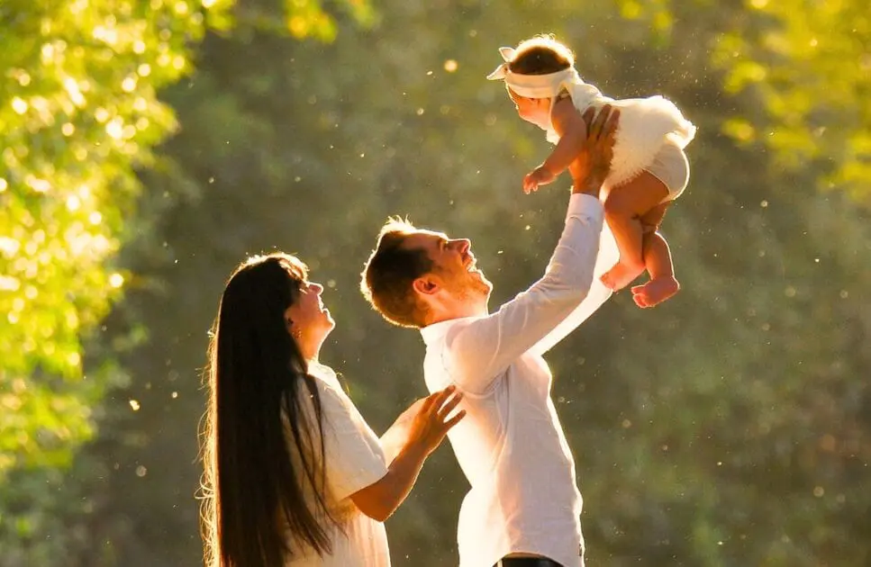 Happy parents holding their baby up in the air. Testing Functional Medicine. Baby Colic. Brisbane Livewell Clinic