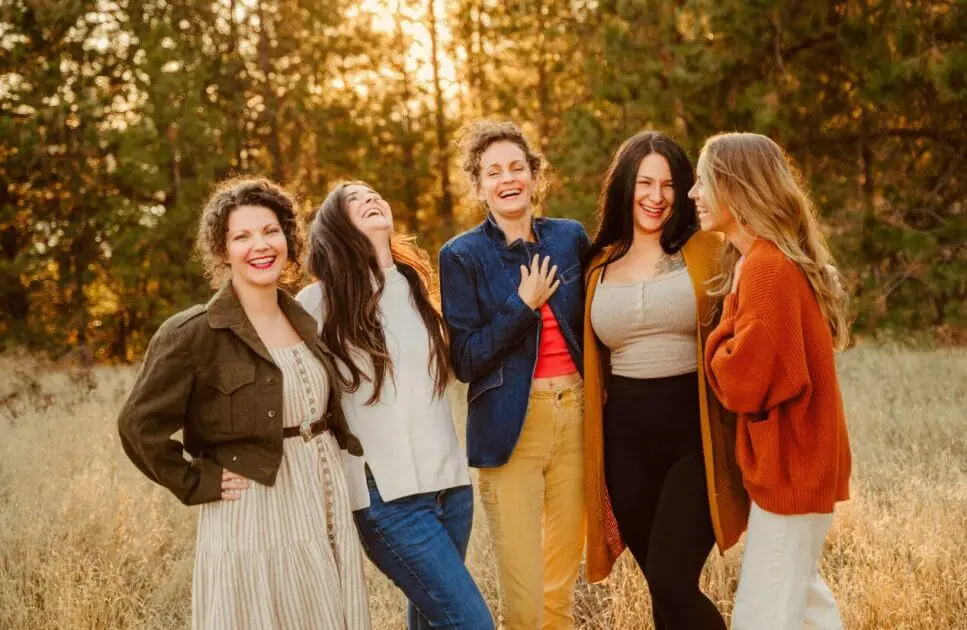 Group of four women bursts into laughter while enjoying a sunny day at the park. Counselling Services. Brisbane Livewell Clinic. Hypnotherapy Wavell Heights. Hypnosis in Wavell Heights.