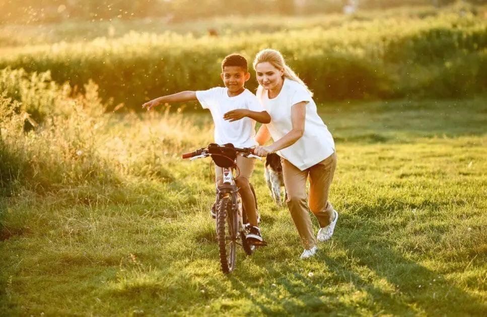 Woman teaching her son how to ride a bike. Hypnotherapy near Stafford. Osteopath Coorparoo. Brisbane Livewell Clinic