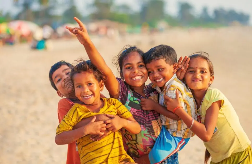 A group of happy children playing on a sandy beach. Naturopath for Children. Heavy Metal Detox for Kids. Brisbane Livewell Clinic