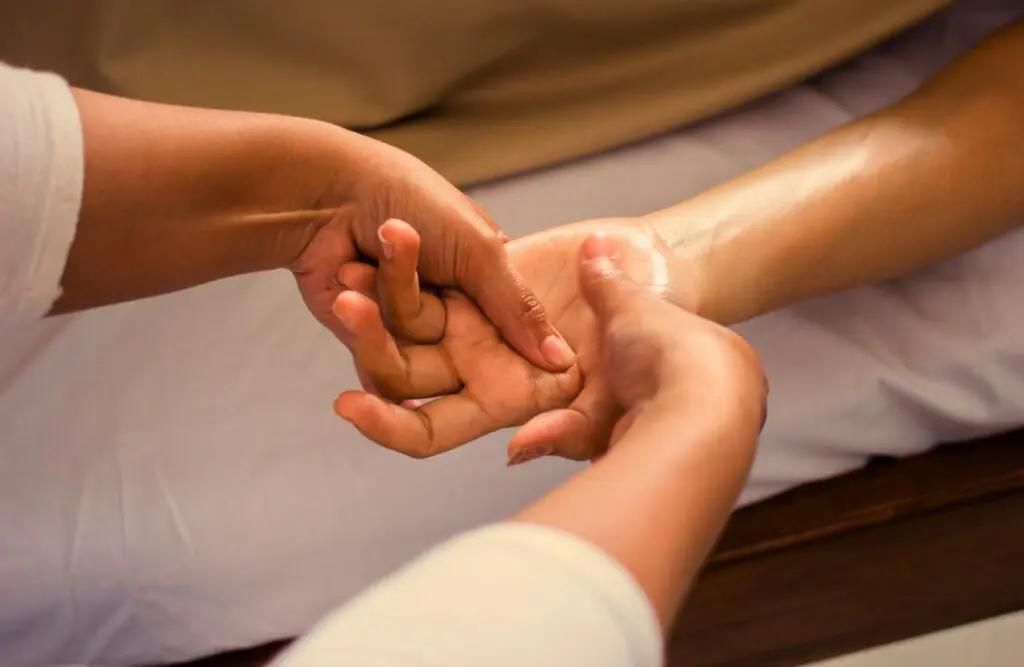 Woman receiving hand massage. Can Bowen Therapy Help Sciatica. Massage Chermside. Brisbane Livewell Clinic