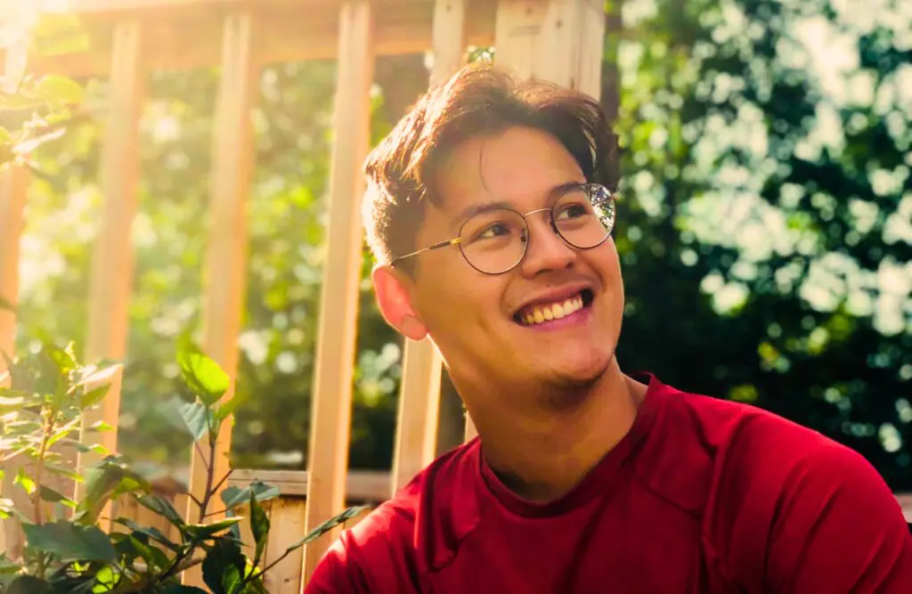 Smiling man wearing eyeglasses looking away. Counselling Stafford. Holistic Counselling for Identity Loss. Brisbane Livewell Clinic