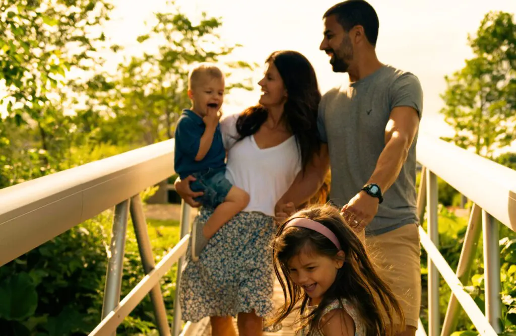 Family walking across a footbridge. Naturopathy. Best Naturopath Near Me. Bowen Therapy on the Sunshine Coast. Brisbane Livewell Clinic