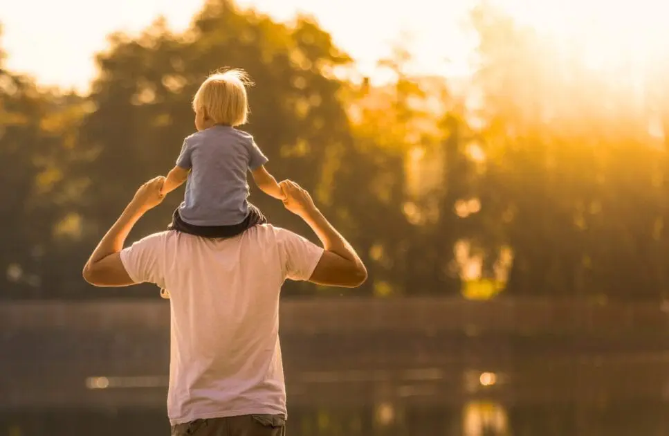 Father piggybacks his son near the lake. Hypnotherapy near Virginia. Brisbane Livewell Clinic