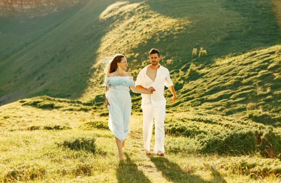Couple walks hand in hand in the mountains, enjoying the breathtaking views. Marriage Counselling Brisbane. Brisbane Livewell Clinic