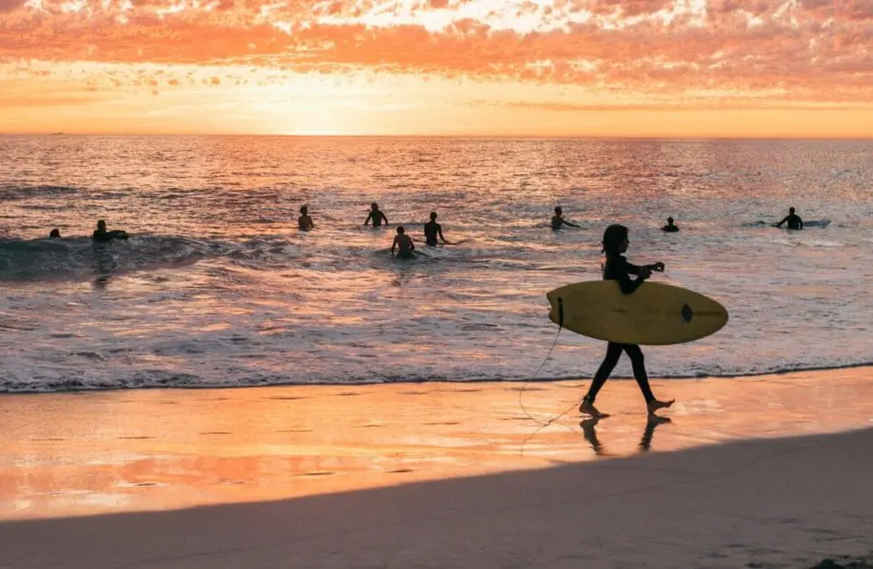 Surfers at the beach at sunset. Hypnotherapy near Northgate. Brisbane Livewell Clinic